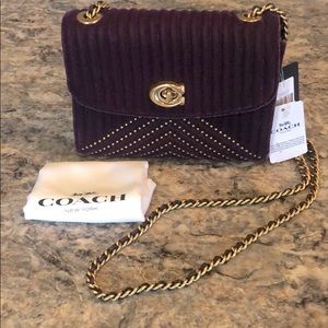 Coach Plum Parker 18 Velvet w/ rivets MSRP $350